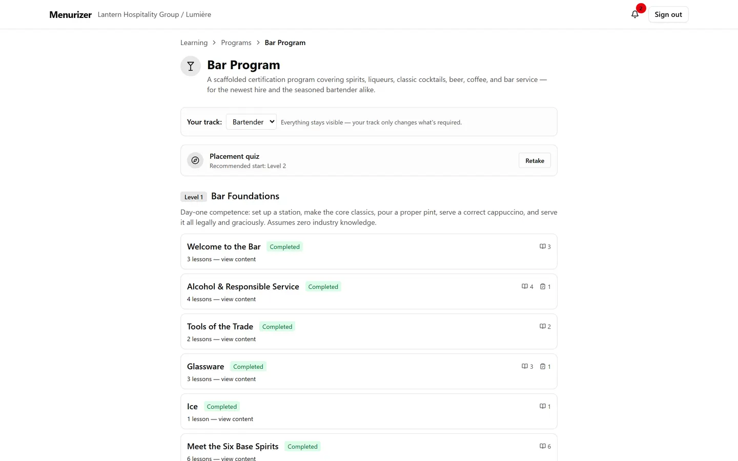 A bartender's Bar Program page: Level 1 sections all completed, placement recommending Level 2